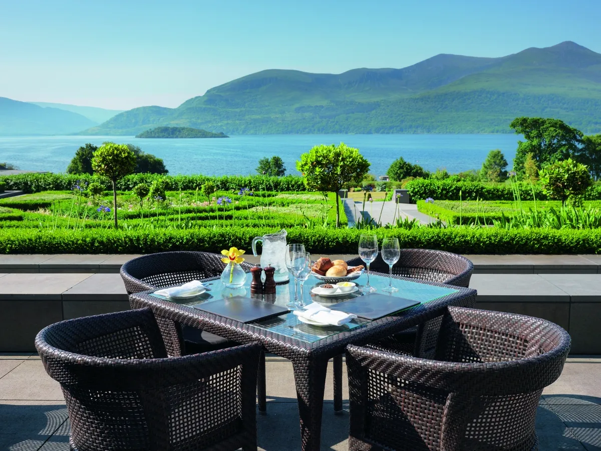 The Europe Hotel terrace dining table set for lunch with Lough Leane and mountains beyond