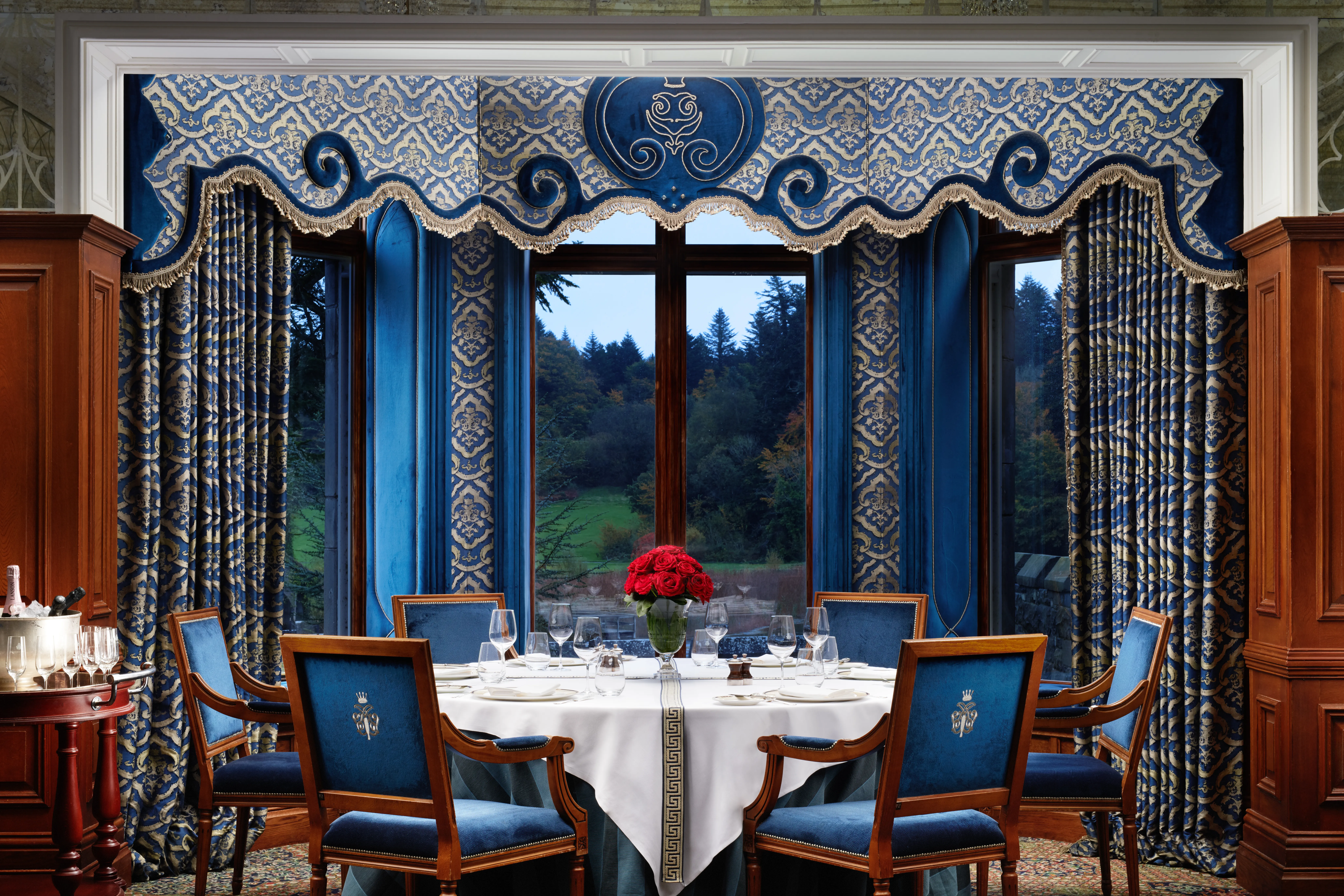 Ashford Castle Connaught Room with royal blue damask drapes and formal table setting