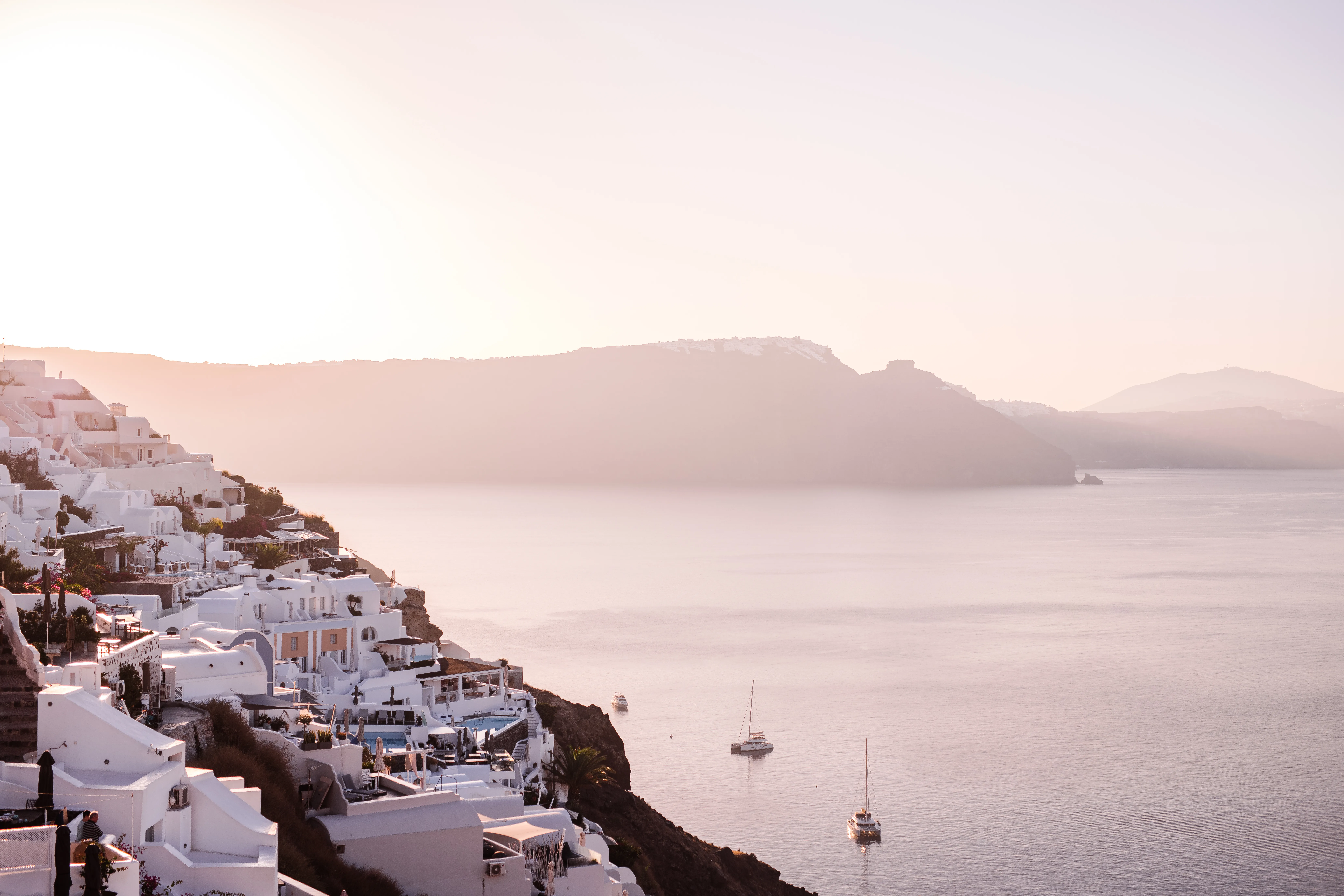 Greece, Where whitewashed villages crown volcanic cliffs above the Aegean.