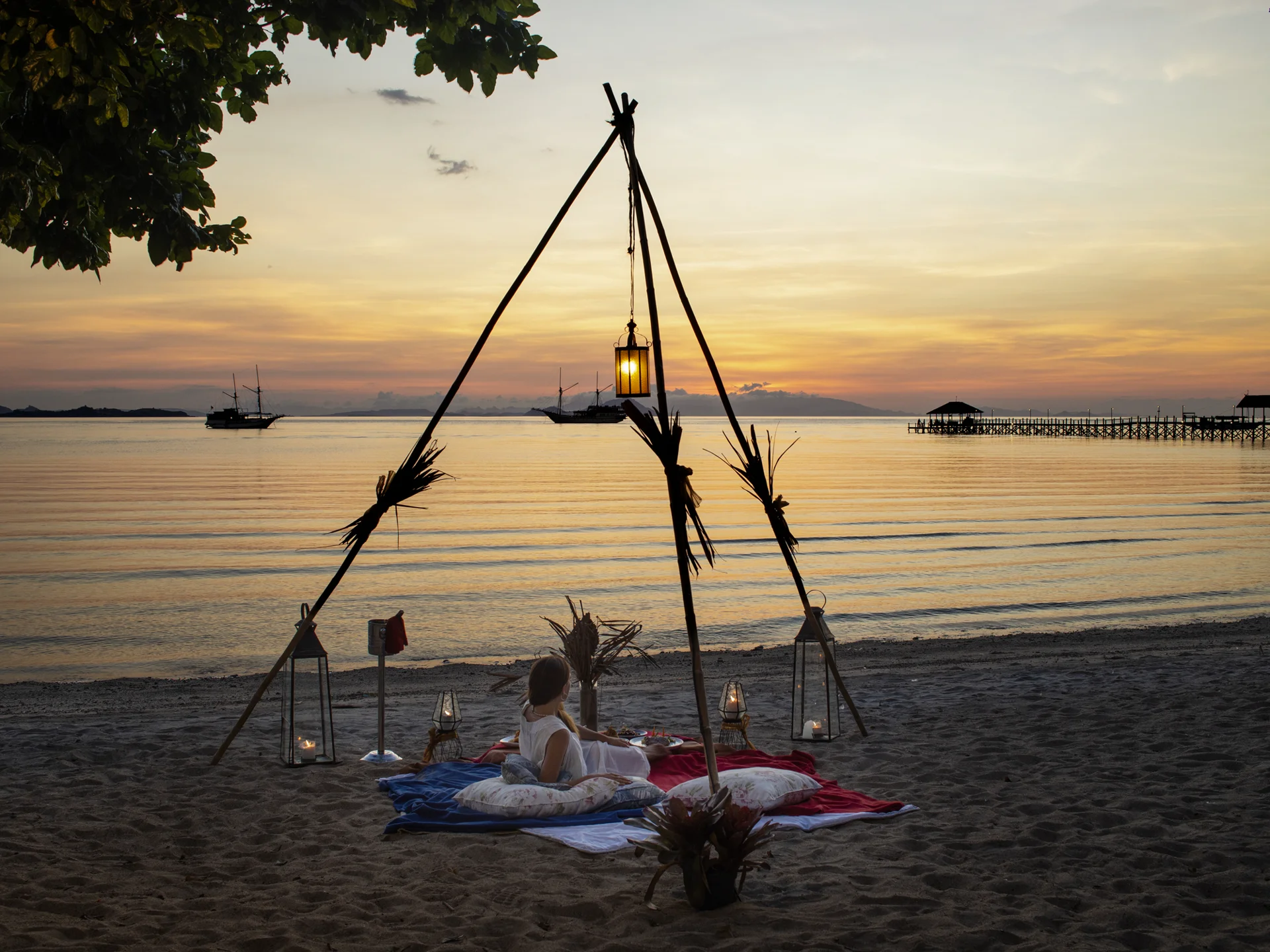 Plataran Komodo sunset picnic dining with hanging lanterns over the water