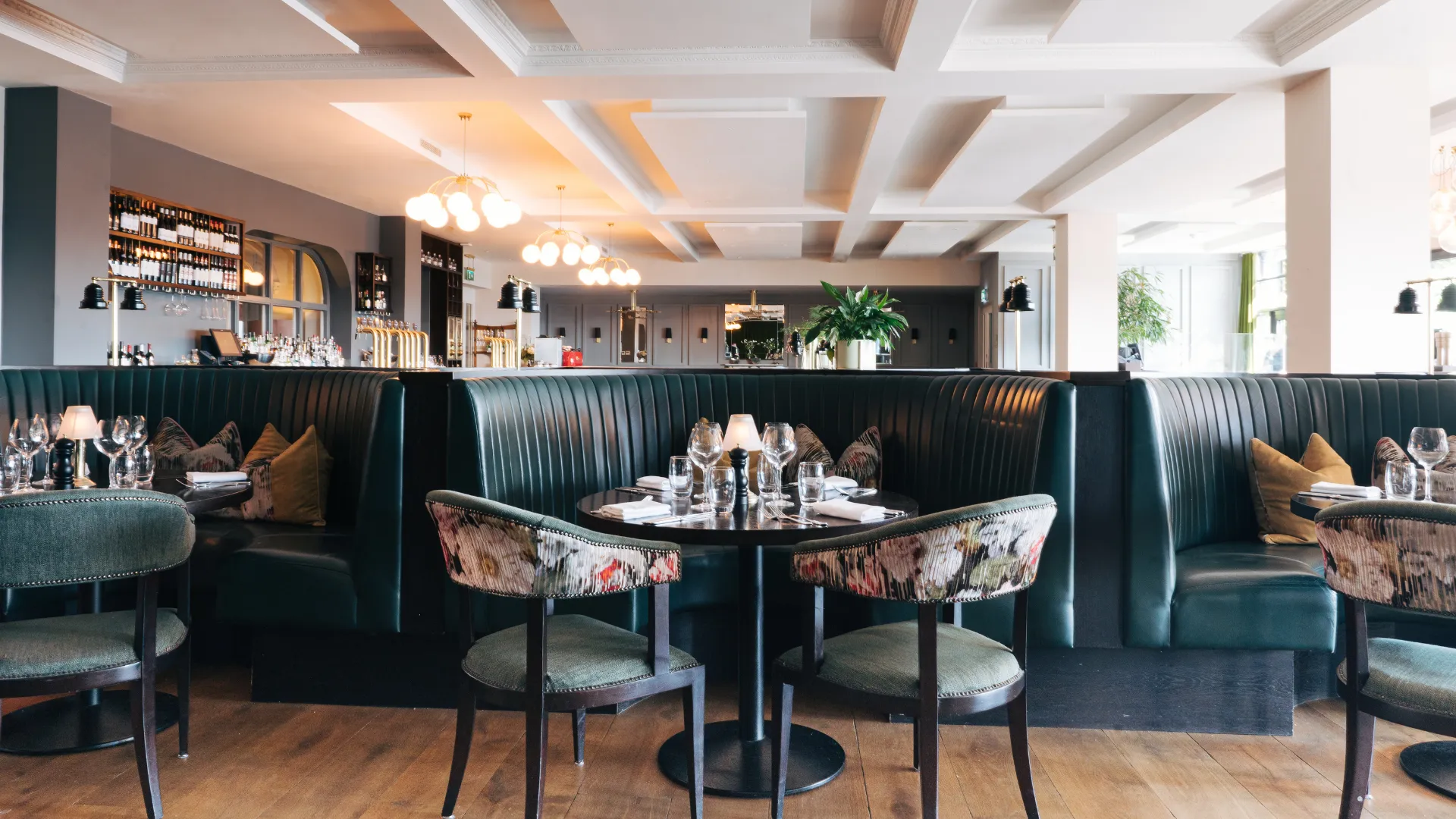 Panorama Bistro at The Montenotte with dark banquettes and floor-to-ceiling wine wall